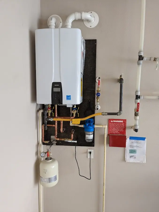 Professional plumber installing copper piping in a Saratoga home